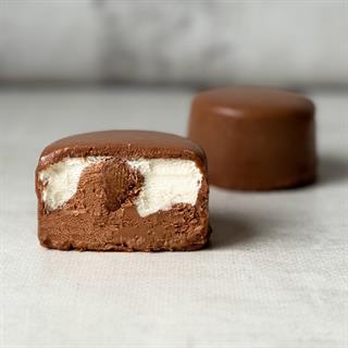 Два слоя из белого и молочного шоколада с хрустящей сердцевиной из фундучного пралине, покрыто молочным шоколадом.